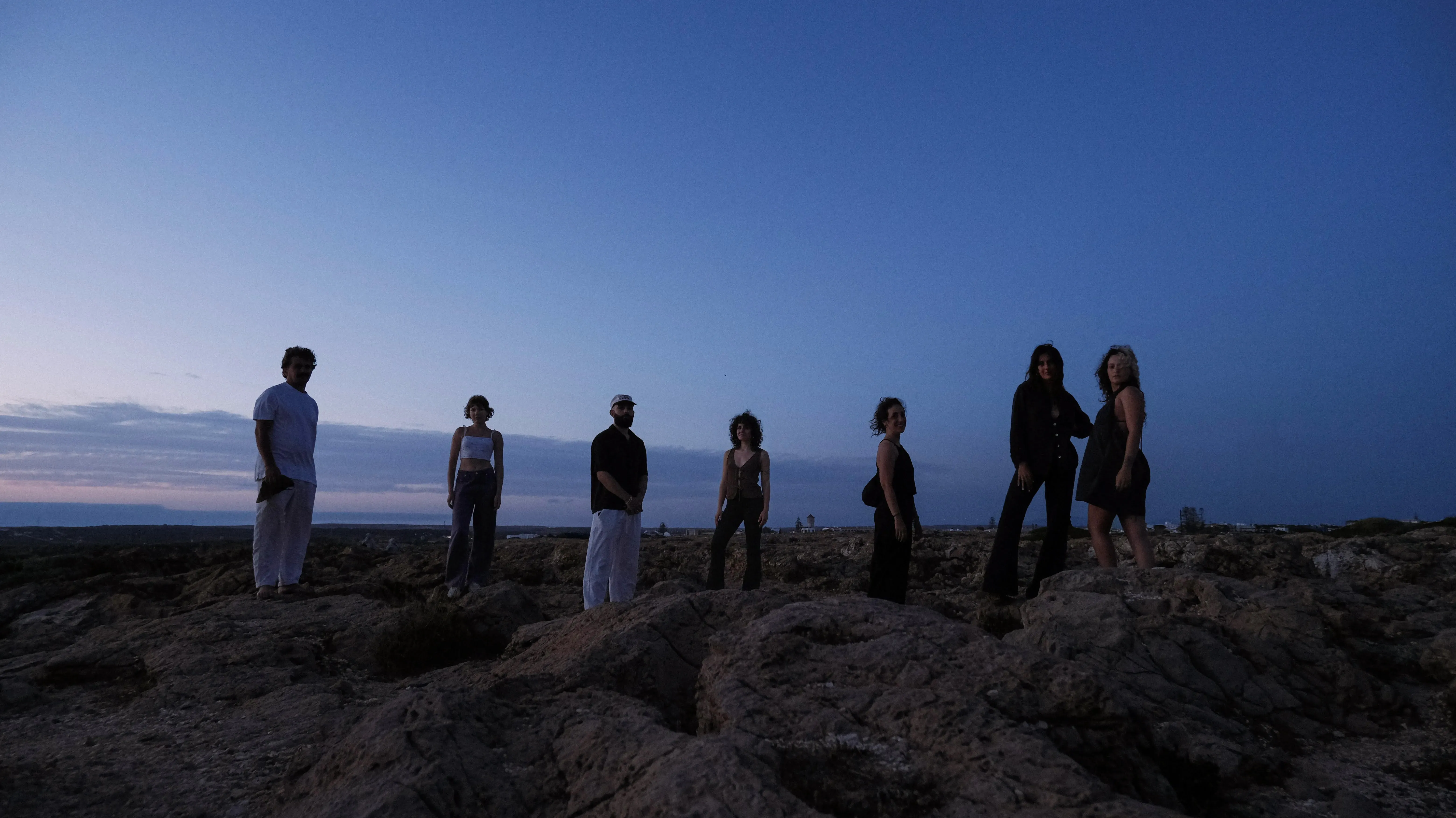 The GDA-V team standing on the rocks at dusk