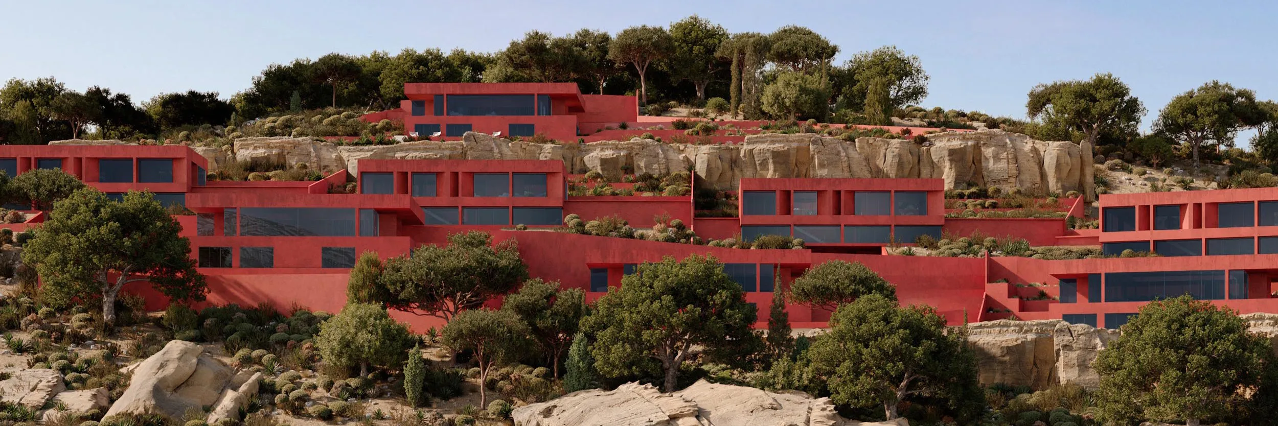 Terraced red buildings along the hillside above the sea