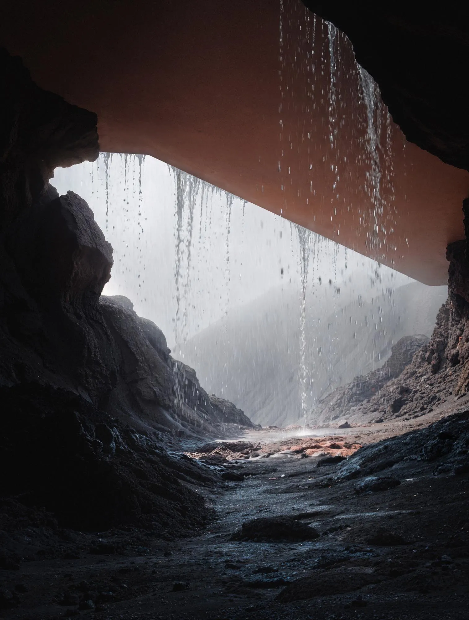 A figure at the cave mouth, sea light