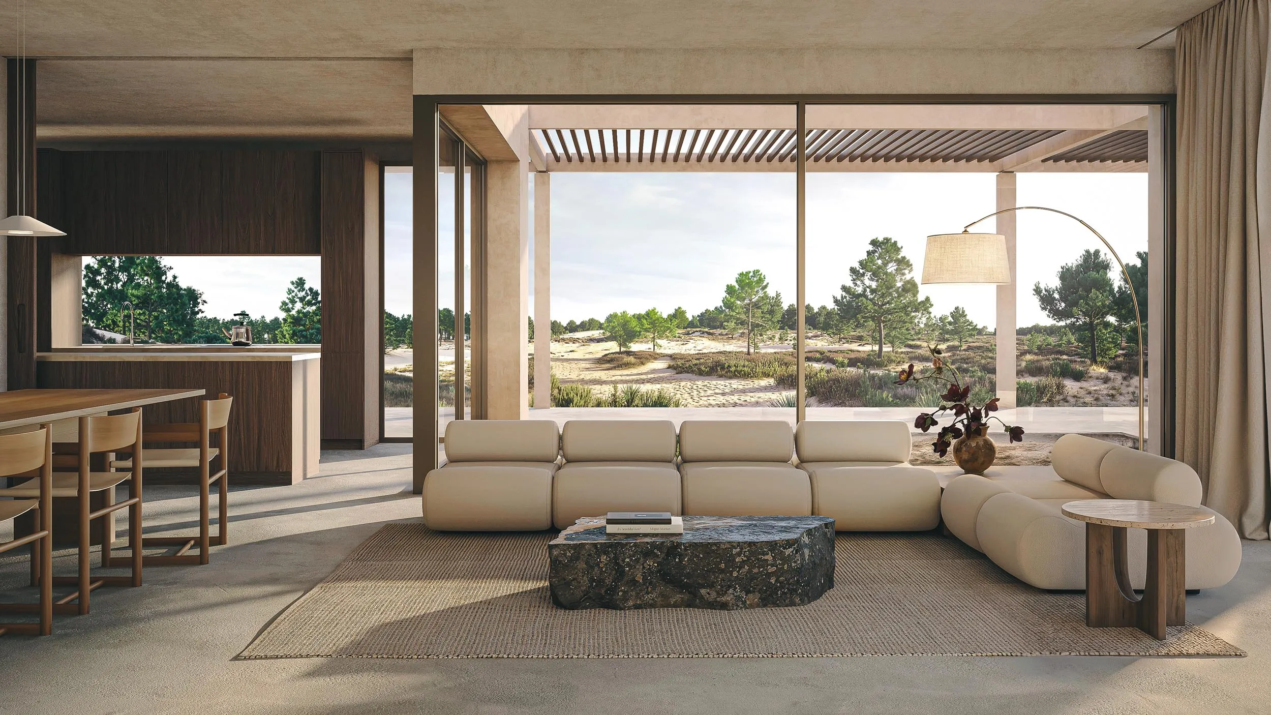 The living room open to the landscape, sofas and dining table under the pergola